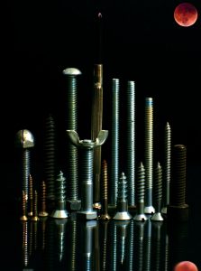 Screws standing on end that look like a city below a total lunar eclipse.